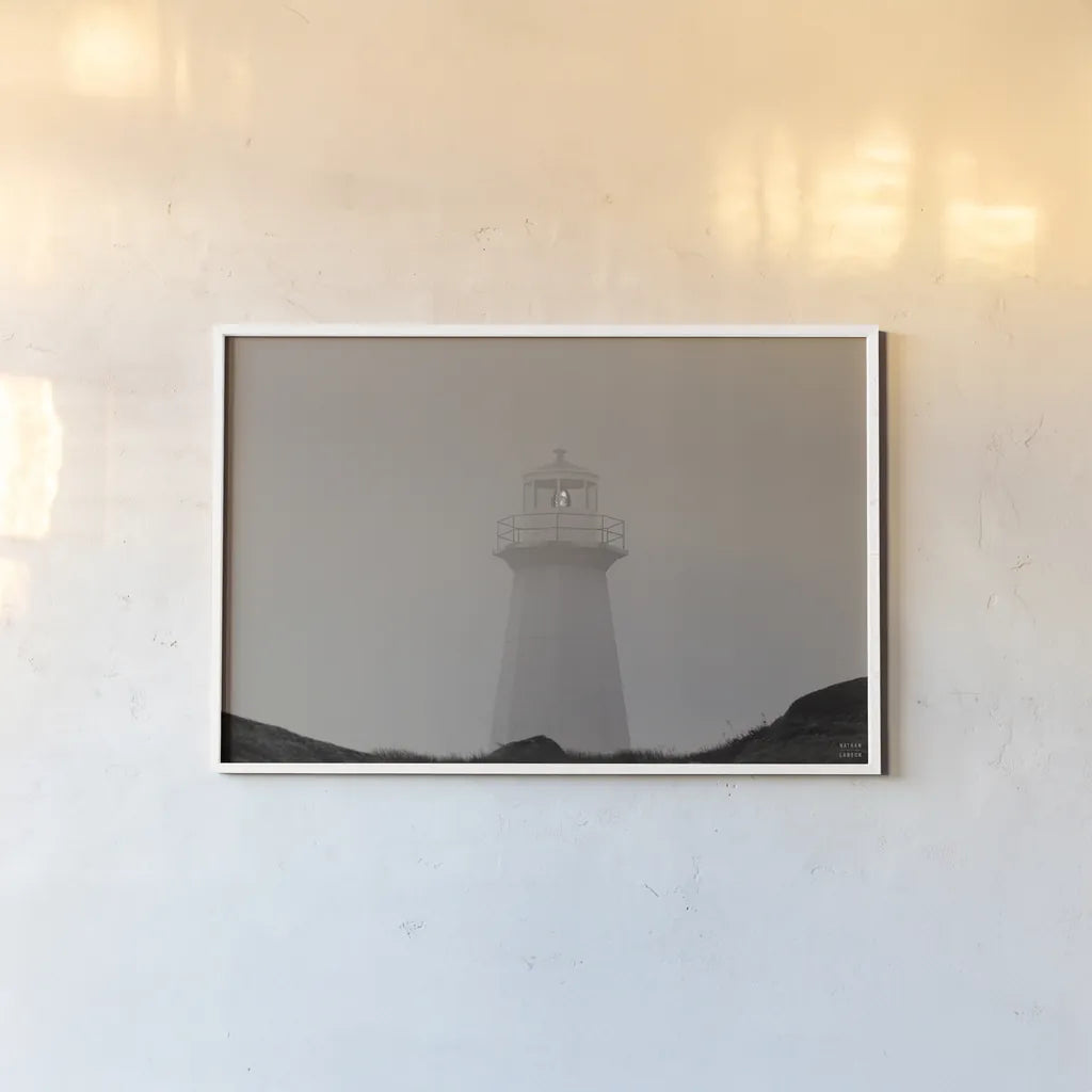 Cape Spear Lighthouse by Nathan Larson. shown as a paper print in a white frame. Available as a archival giclee rolled canvas, fine art paper, or poster print. SKU 100500i.