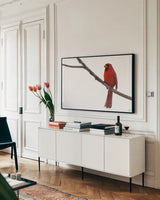 Cardinal on the Mississippi by Nathan Larson. shown as a framed stretched canvas in a living room above a console. Available as a archival giclee rolled canvas, fine art paper, or poster print. SKU 98335i.