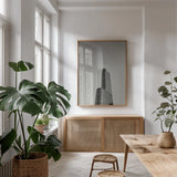 Chicago Skies BW by Nathan Larson. shown as a print in a natural wood frame in a dining room. Available as a archival giclee rolled canvas, fine art paper, or poster print. SKU 104873h.