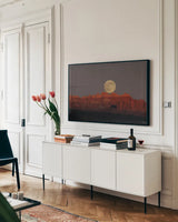 Cold Moon by Nathan Larson. shown as a framed stretched canvas in a living room above a console. Available as a archival giclee rolled canvas, fine art paper, or poster print. SKU 103217i.