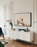 Country Grasses I by Nathan Larson. shown as a framed stretched canvas in a living room above a console. Available as a archival giclee rolled canvas, fine art paper, or poster print. SKU 75477i.