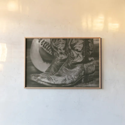 Cowboy Boots I by Nathan Larson. shown as a paper print in a natural frame. Available as a archival giclee rolled canvas, fine art paper, or poster print. SKU 82727i.