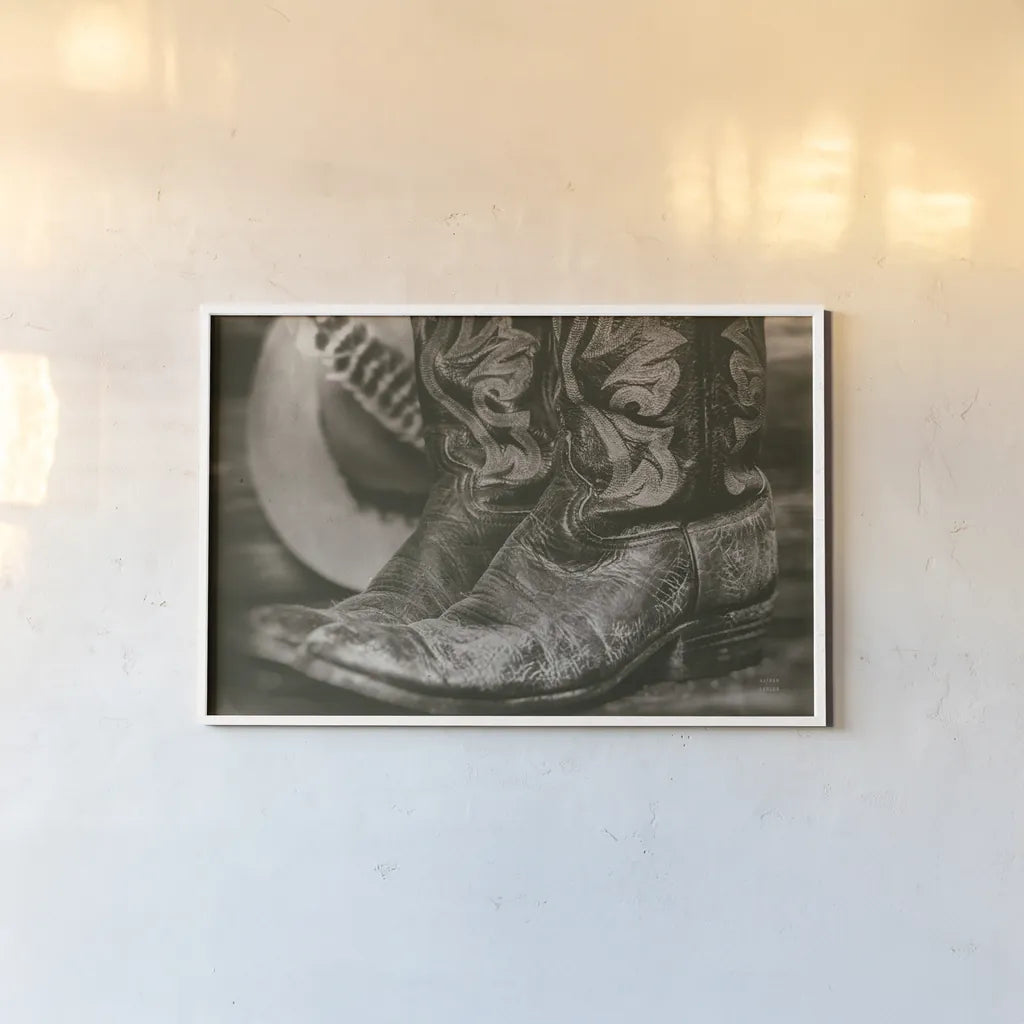 Cowboy Boots I by Nathan Larson. shown as a paper print in a white frame. Available as a archival giclee rolled canvas, fine art paper, or poster print. SKU 82727i.