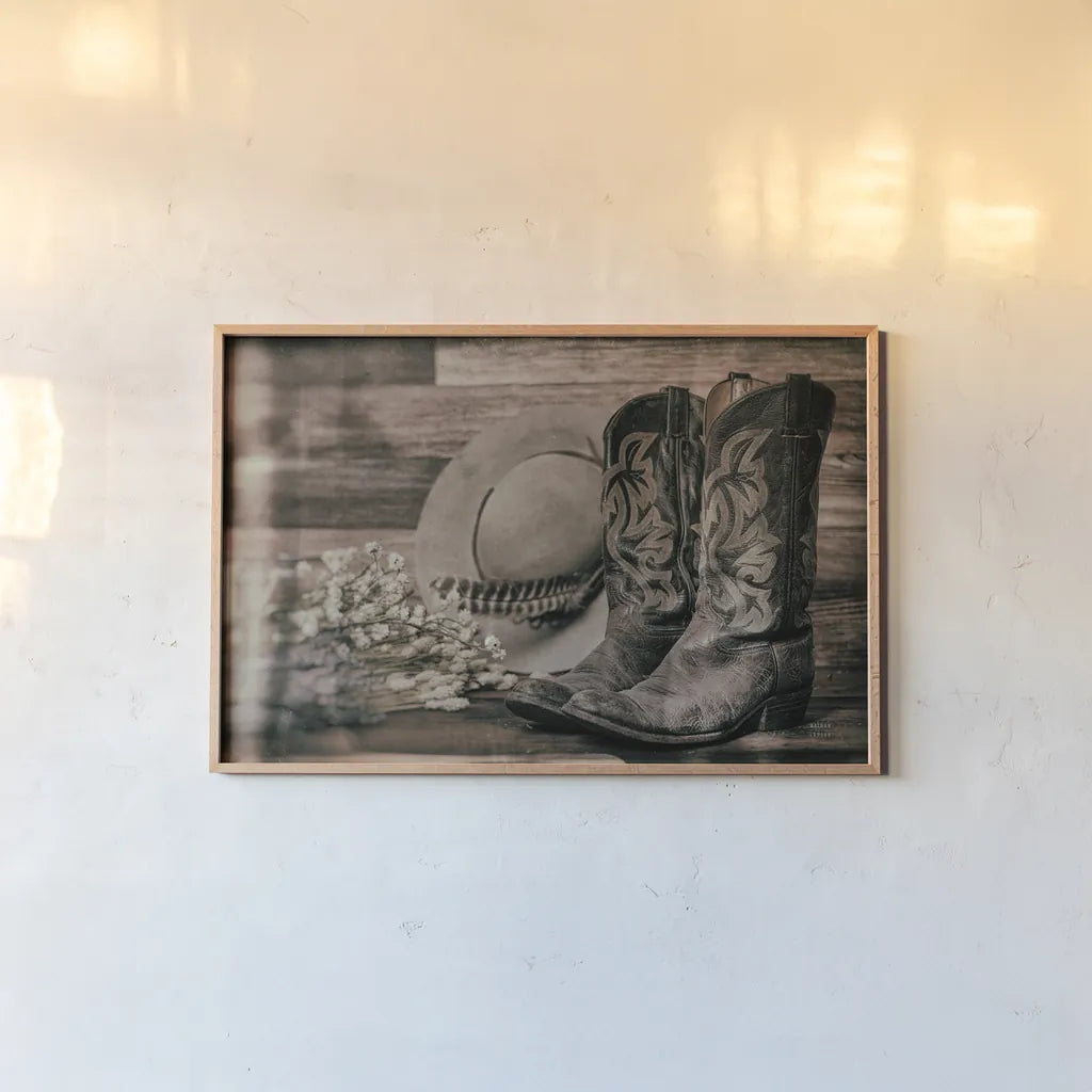 Cowboy Boots III by Nathan Larson. shown as a paper print in a natural frame. Available as a archival giclee rolled canvas, fine art paper, or poster print. SKU 82729i.