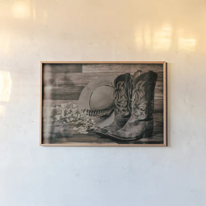 Cowboy Boots III by Nathan Larson. shown as a paper print in a natural frame. Available as a archival giclee rolled canvas, fine art paper, or poster print. SKU 82729i.