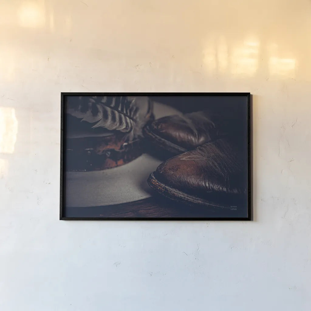 Cowboy Boots IV by Nathan Larson. shown as a paper print in a black flame. Available as a archival giclee rolled canvas, fine art paper, or poster print. SKU 82730i.