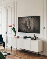 Cowboy Boots IX by Nathan Larson. shown as a framed stretched canvas in a living room above a console. Available as a archival giclee rolled canvas, fine art paper, or poster print. SKU 82735i.