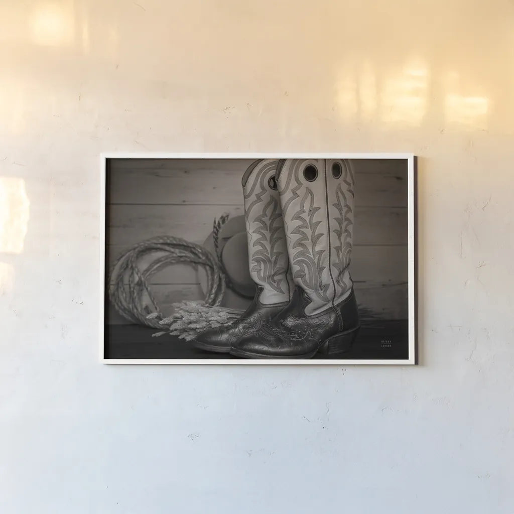 Cowboy Boots IX by Nathan Larson. shown as a paper print in a white frame. Available as a archival giclee rolled canvas, fine art paper, or poster print. SKU 82735i.