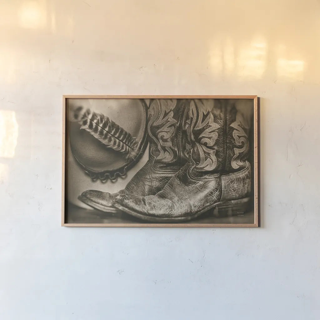 Cowboy Boots VII Sepia by Nathan Larson. shown as a paper print in a natural frame. Available as a archival giclee rolled canvas, fine art paper, or poster print. SKU 83666i.