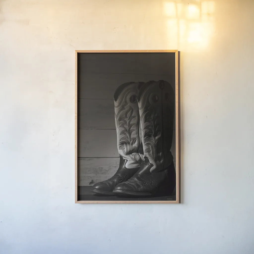 Cowboy Boots VIII BW by Nathan Larson. shown as a paper print in a natural frame. Available as a archival giclee rolled canvas, fine art paper, or poster print. SKU 82739h.