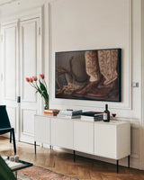 Cowboy Boots XI by Nathan Larson. shown as a framed stretched canvas in a living room above a console. Available as a archival giclee rolled canvas, fine art paper, or poster print. SKU 82736i.