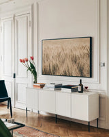 Dakota Wheat Fields by Nathan Larson. shown as a framed stretched canvas in a living room above a console. Available as a archival giclee rolled canvas, fine art paper, or poster print. SKU 71167i.
