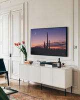 Desert Moons by Nathan Larson. shown as a framed stretched canvas in a living room above a console. Available as a archival giclee rolled canvas, fine art paper, or poster print. SKU 76440i.