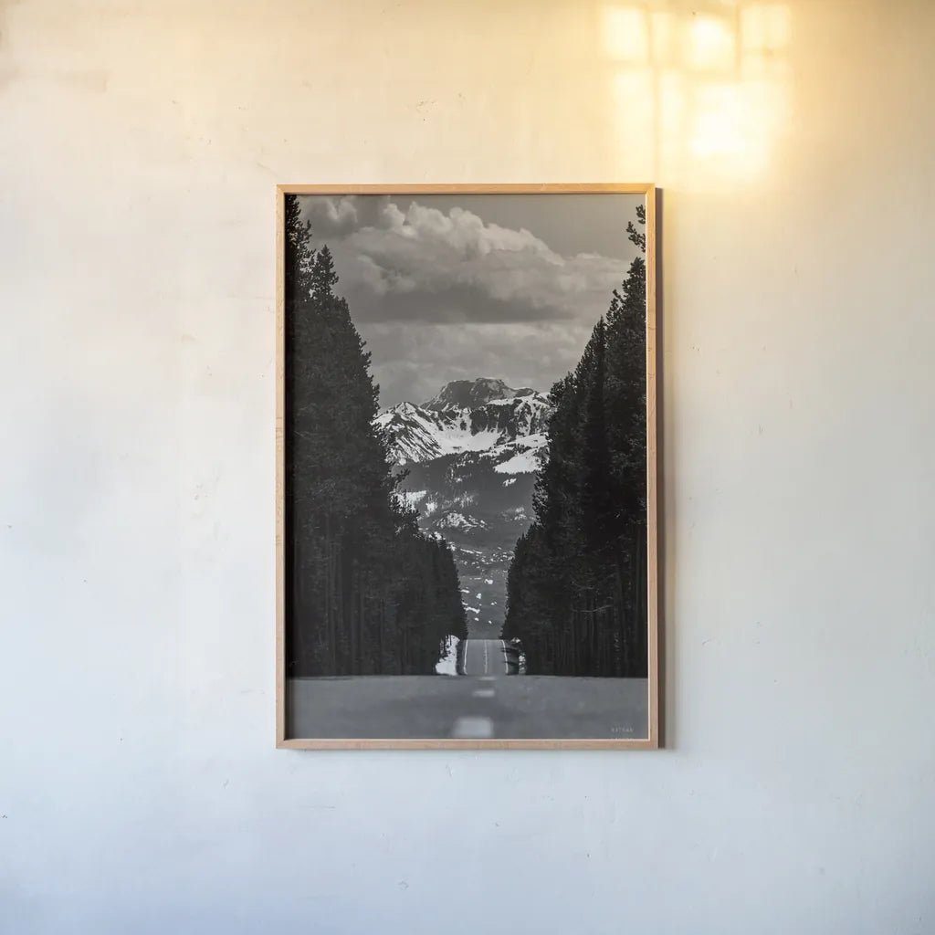 Driving into the Tetons by Nathan Larson. shown as a paper print in a natural frame. Available as a archival giclee rolled canvas, fine art paper, or poster print. SKU 92539h.