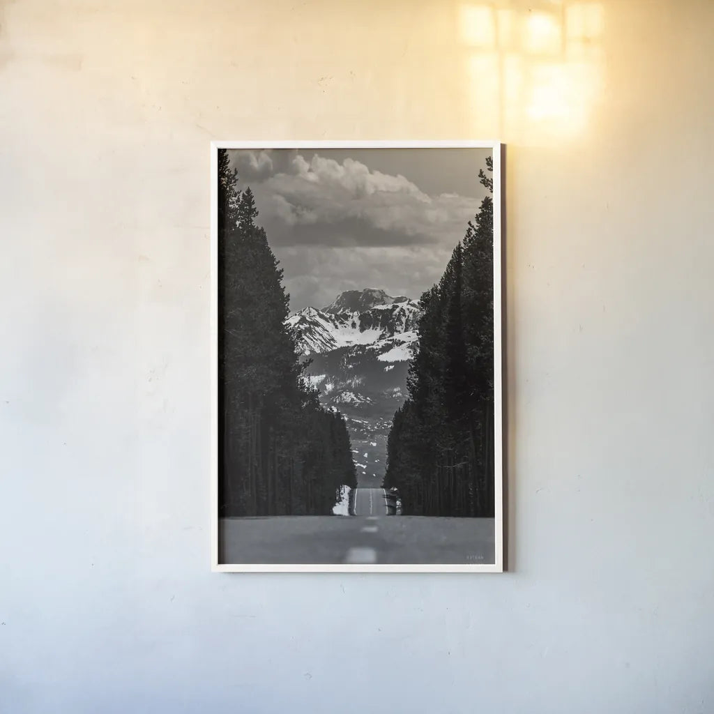Driving into the Tetons by Nathan Larson. shown as a paper print in a white frame. Available as a archival giclee rolled canvas, fine art paper, or poster print. SKU 92539h.