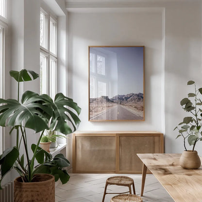 Dusty Desert Dreams Road by Nathan Larson. shown as a print in a natural wood frame in a dining room. Available as a archival giclee rolled canvas, fine art paper, or poster print. SKU 72031h.