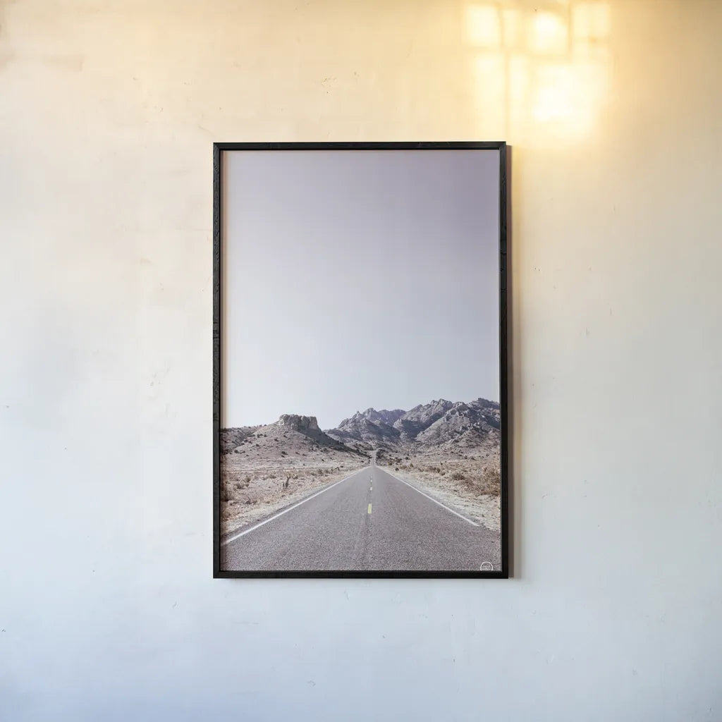 Dusty Desert Dreams Road by Nathan Larson. shown as a paper print in a black flame. Available as a archival giclee rolled canvas, fine art paper, or poster print. SKU 72031h.