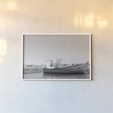 Fishing Boat Rest BW by Nathan Larson. shown as a paper print in a white frame. Available as a archival giclee rolled canvas, fine art paper, or poster print. SKU 103183i.