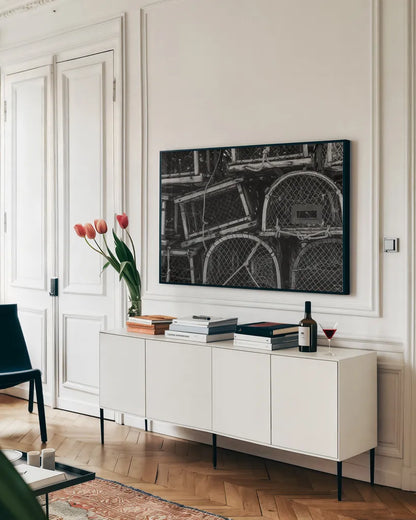 Fishing Village Traps by Nathan Larson. shown as a framed stretched canvas in a living room above a console. Available as a archival giclee rolled canvas, fine art paper, or poster print. SKU 102033i.