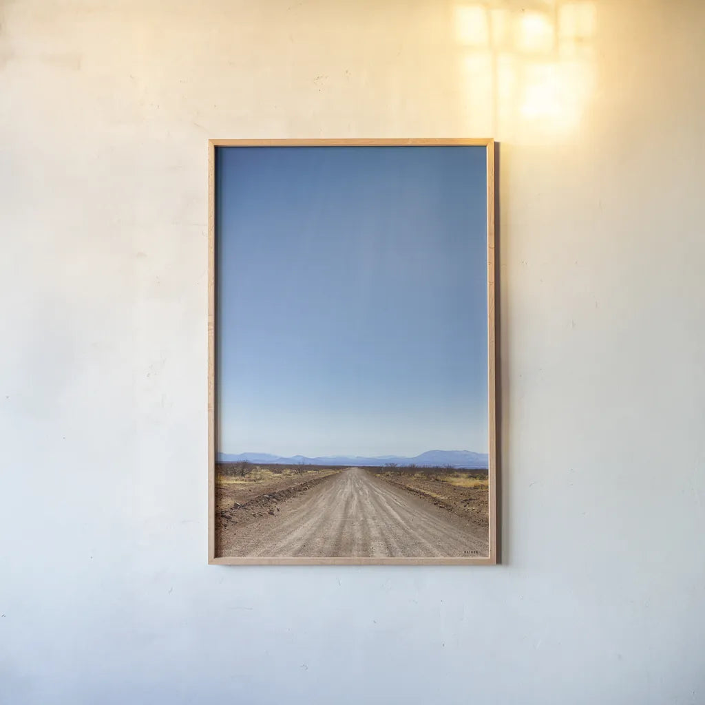 Follow Your Road by Nathan Larson. shown as a paper print in a natural frame. Available as a archival giclee rolled canvas, fine art paper, or poster print. SKU 77275h.