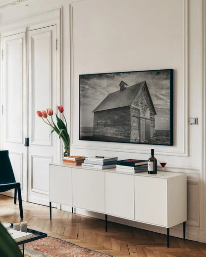 Forgotten Farm by Nathan Larson. shown as a framed stretched canvas in a living room above a console. Available as a archival giclee rolled canvas, fine art paper, or poster print. SKU 98340i.