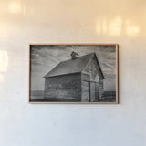Forgotten Farm by Nathan Larson. shown as a paper print in a natural frame. Available as a archival giclee rolled canvas, fine art paper, or poster print. SKU 98340i.