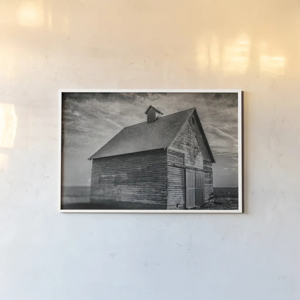 Forgotten Farm by Nathan Larson. shown as a paper print in a white frame. Available as a archival giclee rolled canvas, fine art paper, or poster print. SKU 98340i.