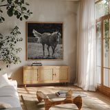 Frolick by Nathan Larson. Shown in a natural wood frame in a cozy modern living room. Available as an archival giclee rolled canvas, fine art paper, or poster print. SKU 83981a.