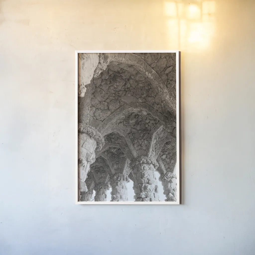 Gaudi Vaults I by Nathan Larson. shown as a paper print in a white frame. Available as a archival giclee rolled canvas, fine art paper, or poster print. SKU 87718h.