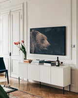 Gentle Grizzly by Nathan Larson. shown as a framed stretched canvas in a living room above a console. Available as a archival giclee rolled canvas, fine art paper, or poster print. SKU 100754i.