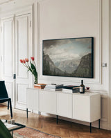 Glacier National Park Gateway by Nathan Larson. shown as a framed stretched canvas in a living room above a console. Available as a archival giclee rolled canvas, fine art paper, or poster print. SKU 87646i.
