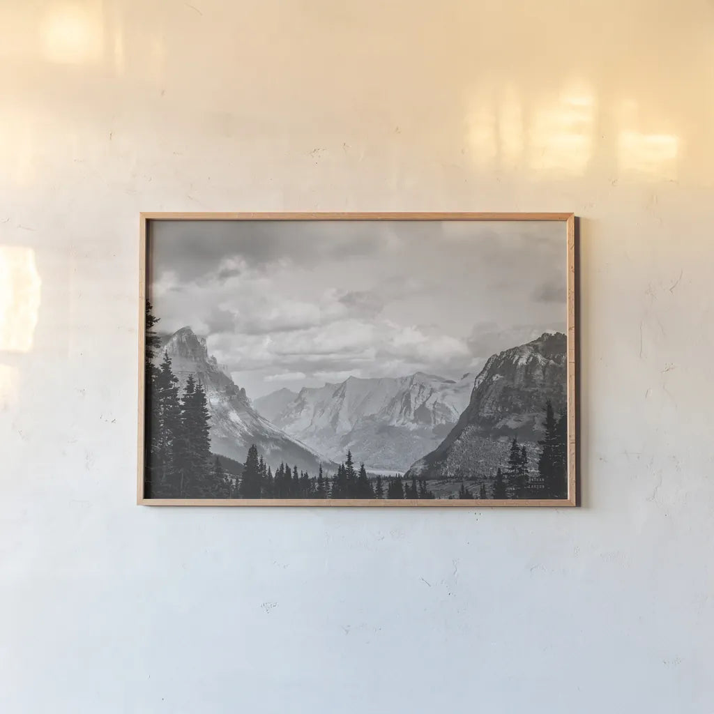 Glacier National Park Gateway BW by Nathan Larson. shown as a paper print in a natural frame. Available as a archival giclee rolled canvas, fine art paper, or poster print. SKU 87647i.