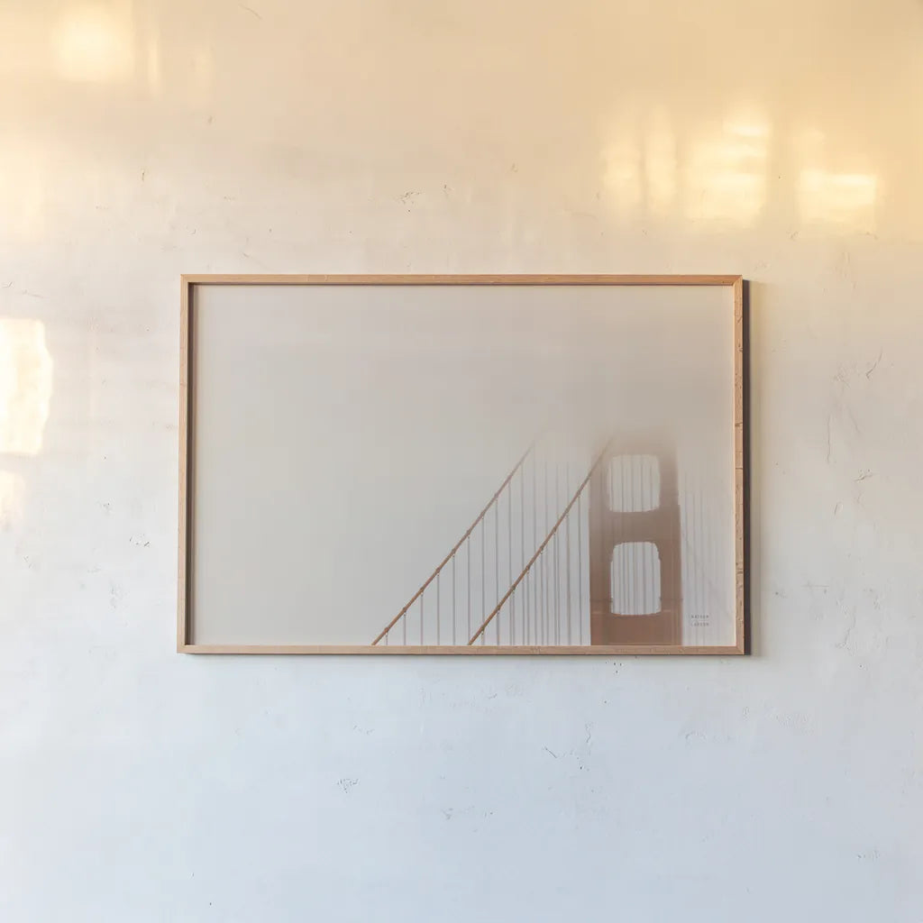 Golden Gate Fog by Nathan Larson. shown as a paper print in a natural frame. Available as a archival giclee rolled canvas, fine art paper, or poster print. SKU 87945i.