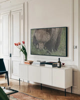 Grazing Grizzly by Nathan Larson. shown as a framed stretched canvas in a living room above a console. Available as a archival giclee rolled canvas, fine art paper, or poster print. SKU 92567i.