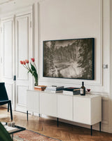 Hidden Falls by Nathan Larson. shown as a framed stretched canvas in a living room above a console. Available as a archival giclee rolled canvas, fine art paper, or poster print. SKU 82410i.