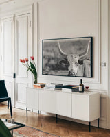 High Desert Herd BW by Nathan Larson. shown as a framed stretched canvas in a living room above a console. Available as a archival giclee rolled canvas, fine art paper, or poster print. SKU 102774i.