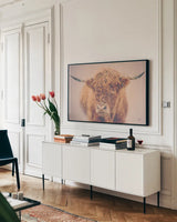 Highland in the Winter Fog by Nathan Larson. shown as a framed stretched canvas in a living room above a console. Available as a archival giclee rolled canvas, fine art paper, or poster print. SKU 77565i.