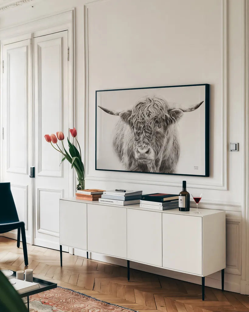 Highland in the Winter Fog BW by Nathan Larson. shown as a framed stretched canvas in a living room above a console. Available as a archival giclee rolled canvas, fine art paper, or poster print. SKU 77566i.