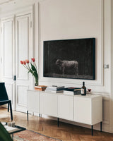 Hill Top Highland BW by Nathan Larson. shown as a framed stretched canvas in a living room above a console. Available as a archival giclee rolled canvas, fine art paper, or poster print. SKU 89479i.