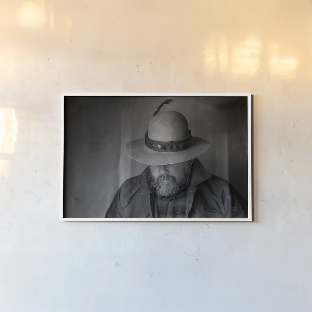 Home on the Range Cowboy II by Nathan Larson. shown as a paper print in a white frame. Available as a archival giclee rolled canvas, fine art paper, or poster print. SKU 77196i.