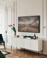 Into The Storm by Nathan Larson. shown as a framed stretched canvas in a living room above a console. Available as a archival giclee rolled canvas, fine art paper, or poster print. SKU 70271i.