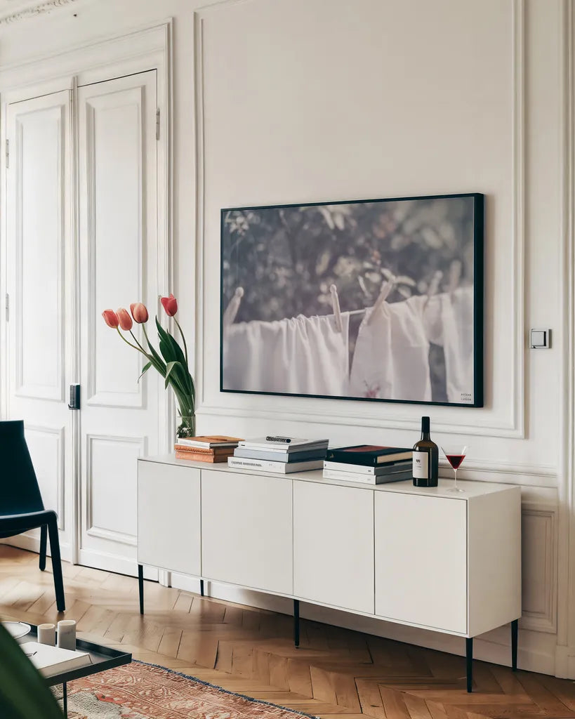 Laundry Day I by Nathan Larson. shown as a framed stretched canvas in a living room above a console. Available as a archival giclee rolled canvas, fine art paper, or poster print. SKU 99407i.