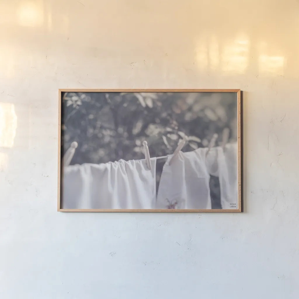Laundry Day I by Nathan Larson. shown as a paper print in a natural frame. Available as a archival giclee rolled canvas, fine art paper, or poster print. SKU 99407i.