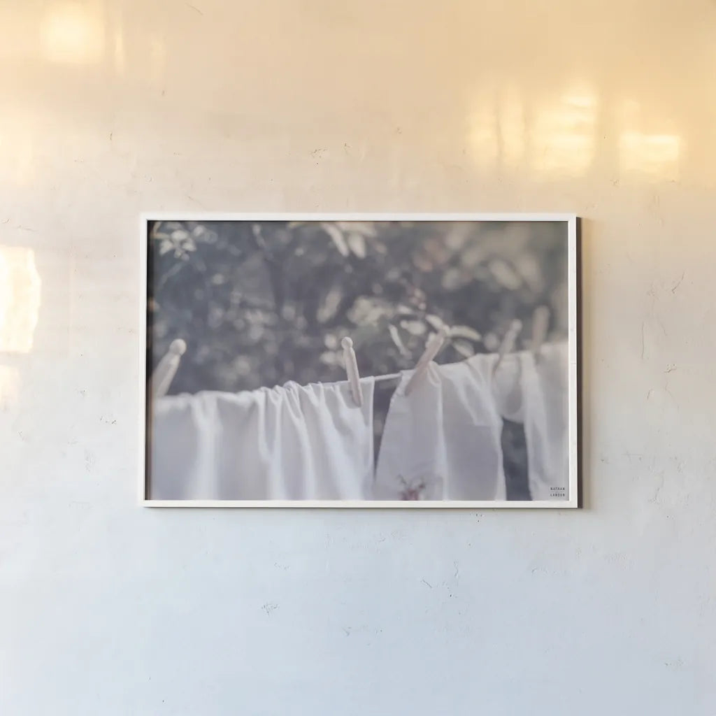 Laundry Day I by Nathan Larson. shown as a paper print in a white frame. Available as a archival giclee rolled canvas, fine art paper, or poster print. SKU 99407i.