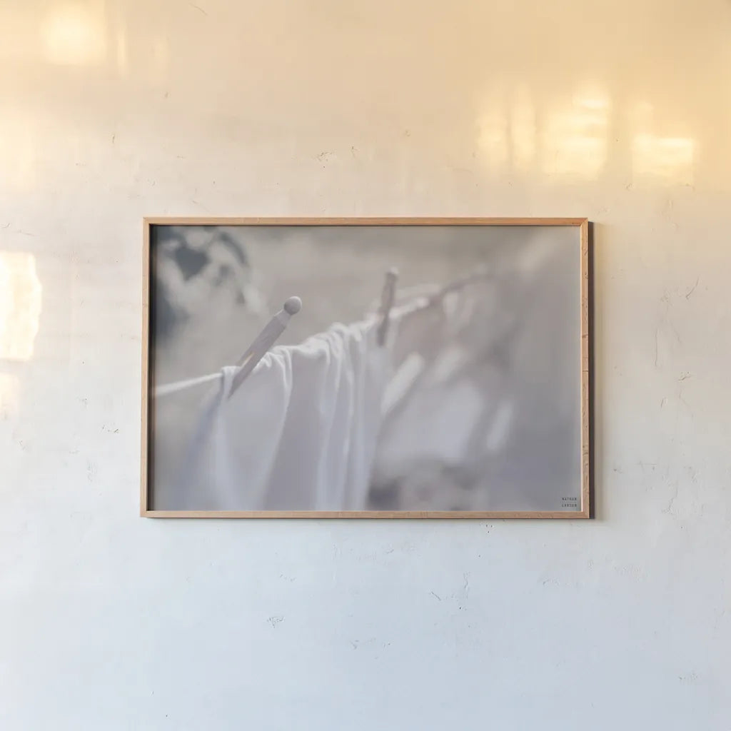 Laundry Day II by Nathan Larson. shown as a paper print in a natural frame. Available as a archival giclee rolled canvas, fine art paper, or poster print. SKU 99408i.