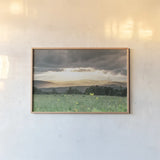 Laying in the Flowers by Nathan Larson. shown as a paper print in a natural frame. Available as a archival giclee rolled canvas, fine art paper, or poster print. SKU 71622i.