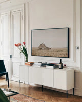 Leaning Barn by Nathan Larson. shown as a framed stretched canvas in a living room above a console. Available as a archival giclee rolled canvas, fine art paper, or poster print. SKU 86062i.
