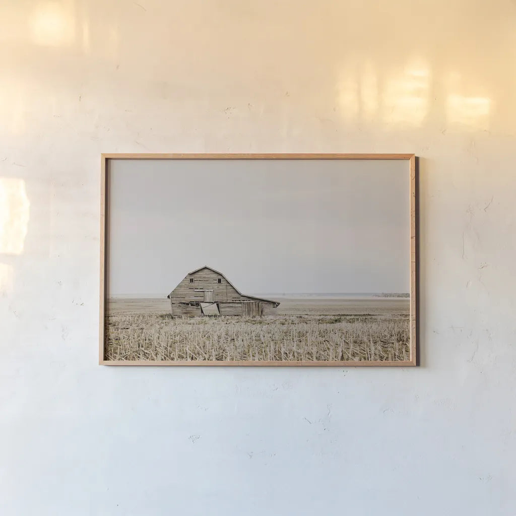 Leaning Barn by Nathan Larson. shown as a paper print in a natural frame. Available as a archival giclee rolled canvas, fine art paper, or poster print. SKU 86062i.