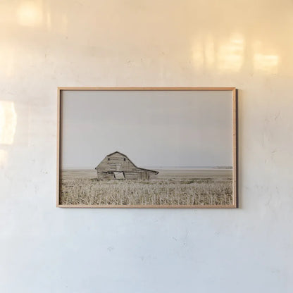 Leaning Barn by Nathan Larson. shown as a paper print in a natural frame. Available as a archival giclee rolled canvas, fine art paper, or poster print. SKU 86062i.