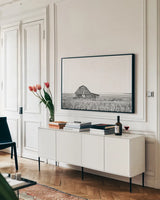Leaning Barn BW by Nathan Larson. shown as a framed stretched canvas in a living room above a console. Available as a archival giclee rolled canvas, fine art paper, or poster print. SKU 86064i.